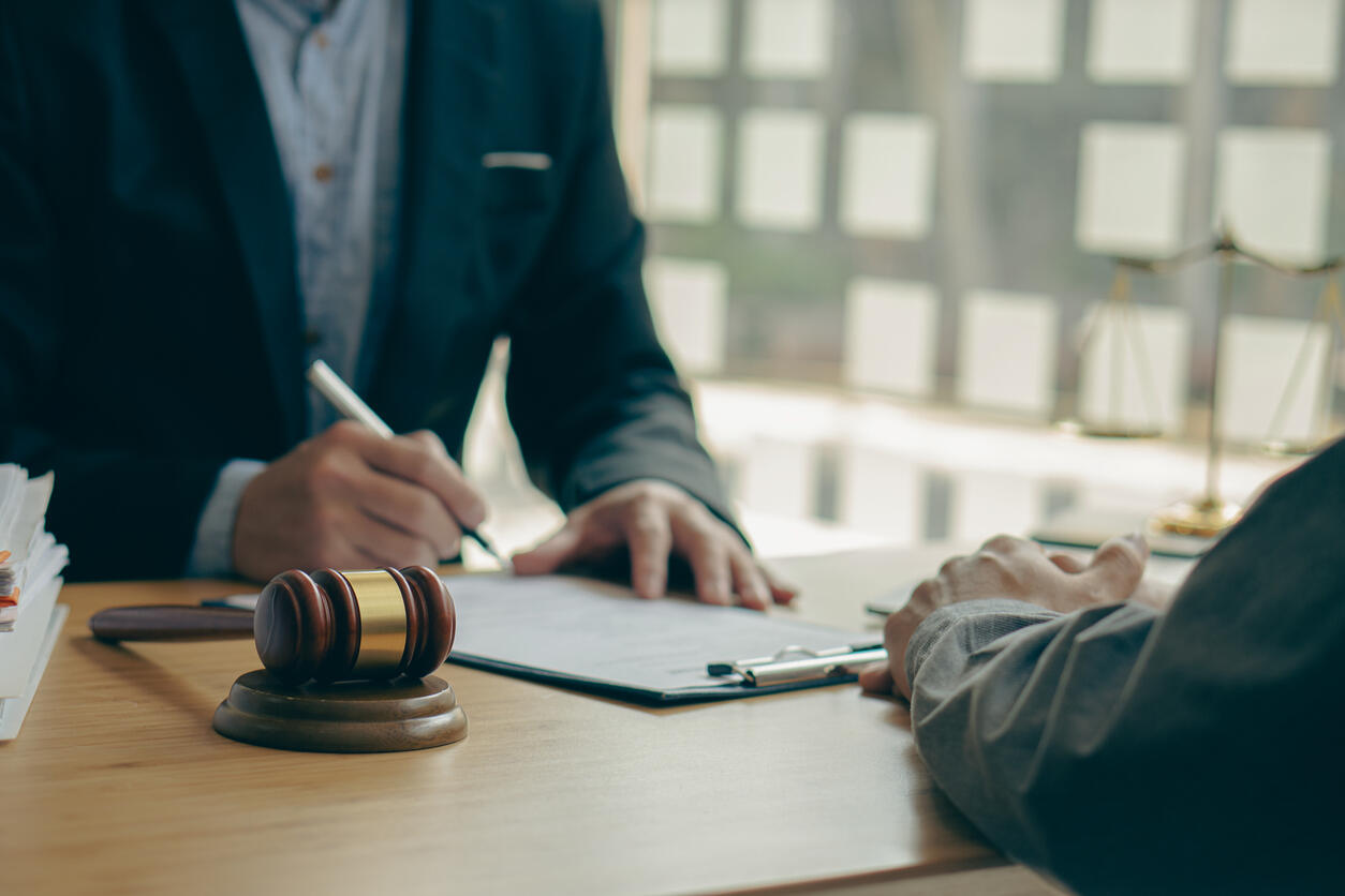 A lawyer advising an individual on employment law matters, symbolizing legal representation for workers' rights in California, including state, city, and federal employees.